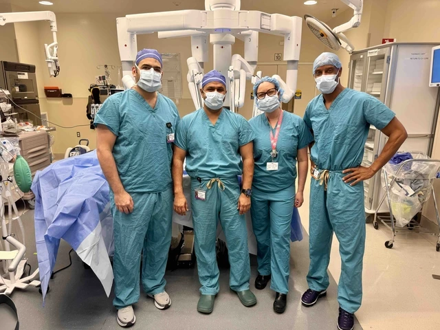 Doctors stand next to a machine in an operating room