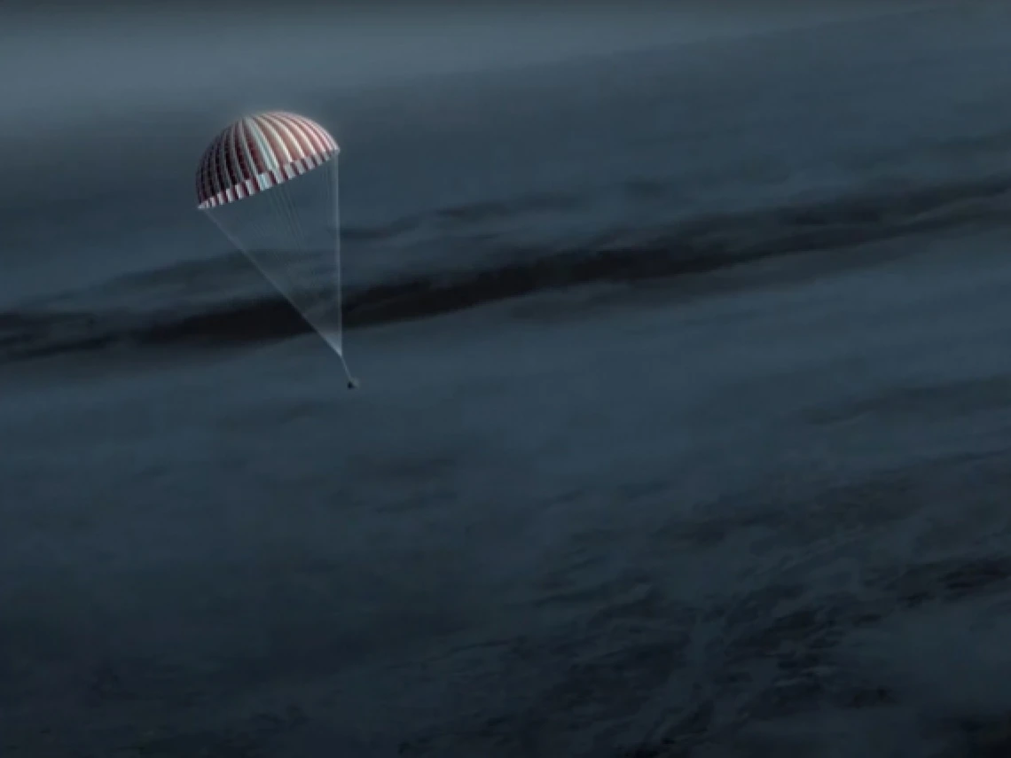 capsule parachuting to Earth